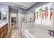 Luxurious bathroom with a soaking tub, glass shower, and a spacious vanity area at 9822 Opal Bridge Ct, Las Vegas, NV 89178