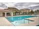 Community pool with lounge chairs and well maintained surrounding landscape at 9822 Opal Bridge Ct, Las Vegas, NV 89178