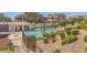 Community pool with lush landscaping and wrought iron fence at 9822 Opal Bridge Ct, Las Vegas, NV 89178