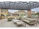 Inviting outdoor patio seating area with comfortable couches and tables at 9822 Opal Bridge Ct, Las Vegas, NV 89178