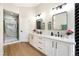 Updated bathroom with double vanity, modern fixtures, and tiled shower at 10017 Snow Crest Pl, Las Vegas, NV 89134