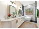 Bright bathroom boasts double vanity, soaking tub, and natural light at 10017 Snow Crest Pl, Las Vegas, NV 89134
