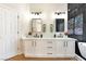 Modern bathroom features double vanity with marble countertop and black fixtures at 10017 Snow Crest Pl, Las Vegas, NV 89134