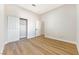 Neutral bedroom with wood floors, closet, and an ensuite door at 10017 Snow Crest Pl, Las Vegas, NV 89134