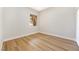 Small, bright bedroom with a window and laminate wood flooring at 10017 Snow Crest Pl, Las Vegas, NV 89134