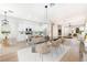 Bright open-concept dining room featuring a black marble table, seating for six, and modern light fixtures at 10017 Snow Crest Pl, Las Vegas, NV 89134