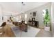 Stylish dining area with a modern table, seating for six, and view of the living room at 10017 Snow Crest Pl, Las Vegas, NV 89134