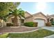 Charming single-story home with a well-manicured lawn, mature trees, and attached two-car garage at 10017 Snow Crest Pl, Las Vegas, NV 89134