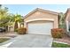 Charming single-story home featuring a two-car garage and well-maintained landscaping with a mature palm tree at 10017 Snow Crest Pl, Las Vegas, NV 89134