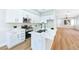 Modern kitchen featuring white cabinets, stainless steel appliances, and an island with a sink at 10017 Snow Crest Pl, Las Vegas, NV 89134