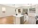 Bright kitchen with white cabinets, a stainless steel dishwasher, and an island sink at 10017 Snow Crest Pl, Las Vegas, NV 89134