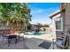 Beautiful backyard featuring a swimming pool, palm trees, and ample patio space at 10046 Floragold Ct, Las Vegas, NV 89147