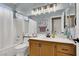 Inviting bathroom features tiled shower/tub, wood vanity, and updated fixtures at 10046 Floragold Ct, Las Vegas, NV 89147