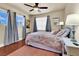 Comfortable bedroom with a ceiling fan, curtains, and natural light from two windows at 10046 Floragold Ct, Las Vegas, NV 89147