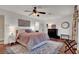 Comfortable bedroom featuring ceiling fan, and ensuite bathroom access at 10046 Floragold Ct, Las Vegas, NV 89147