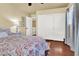 Well-lit bedroom with a ceiling fan, closet space, wooden floors, and neutral walls, offering a serene retreat at 10046 Floragold Ct, Las Vegas, NV 89147