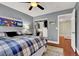 Comfortable bedroom featuring a closet, wood floors, and a blue and white plaid bedspread, plus a view to the hallway at 10046 Floragold Ct, Las Vegas, NV 89147