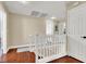 Bright hallway featuring wooden floors and white railings, connecting different areas of the house with style at 10046 Floragold Ct, Las Vegas, NV 89147
