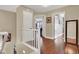 Bright hallway features hardwood flooring, white railings, neutral colored walls, and doorways to other rooms in the home at 10046 Floragold Ct, Las Vegas, NV 89147
