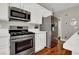 Bright kitchen boasts stainless appliances, white cabinetry, and ample counter space at 10046 Floragold Ct, Las Vegas, NV 89147
