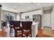 Modern kitchen with white cabinets, stainless steel appliances, and breakfast bar seating at 10046 Floragold Ct, Las Vegas, NV 89147