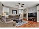 Comfortable living room featuring a fireplace, ceiling fan and hardwood floors at 10046 Floragold Ct, Las Vegas, NV 89147