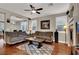 Inviting living room featuring hardwood floors, fireplace, and comfortable seating area at 10046 Floragold Ct, Las Vegas, NV 89147