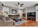 Comfortable living room featuring a fireplace, ceiling fan and hardwood floors at 10046 Floragold Ct, Las Vegas, NV 89147