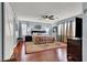 Spacious bedroom with wood floors, a ceiling fan, neutral colored walls, natural light, and elegant decor at 10046 Floragold Ct, Las Vegas, NV 89147