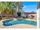 Beautiful pool with a spa surrounded by lush landscaping at 10046 Floragold Ct, Las Vegas, NV 89147