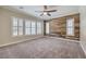 Bedroom with wooden accent wall, carpet flooring, and window shutters at 10149 Terrastone Dr, Las Vegas, NV 89148