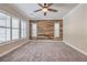 Bedroom featuring rustic accent wall, carpet flooring and bright natural light at 10149 Terrastone Dr, Las Vegas, NV 89148