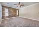 Bedroom featuring a wooden accent wall, carpet flooring, and natural light at 10149 Terrastone Dr, Las Vegas, NV 89148