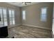 Bedroom with wood-look tile floor, ceiling fan, and shuttered windows providing natural light at 10149 Terrastone Dr, Las Vegas, NV 89148