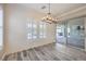 Light-filled dining area featuring wood-look flooring, shiplap wall and sliding glass door at 10149 Terrastone Dr, Las Vegas, NV 89148