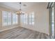 Bright dining space with wood-look floors, shiplap wall, and window shutters at 10149 Terrastone Dr, Las Vegas, NV 89148