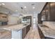 Modern kitchen with granite island, stainless appliances, and seamless flow to living area at 10149 Terrastone Dr, Las Vegas, NV 89148