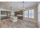 Stylish kitchen featuring granite island, stainless steel appliances, and designer lighting at 10149 Terrastone Dr, Las Vegas, NV 89148