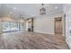 Spacious living room featuring hardwood floors, a modern fireplace and sliding glass doors to the backyard at 10149 Terrastone Dr, Las Vegas, NV 89148