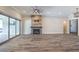 Spacious living room with fireplace, wood-look floors, and access to outdoor patio at 10149 Terrastone Dr, Las Vegas, NV 89148