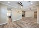 Open concept living room featuring wood-look tile, fireplace, and seamless flow to kitchen at 10149 Terrastone Dr, Las Vegas, NV 89148