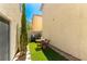 Private backyard with artificial grass, a grill, and outdoor seating at 10254 Martinsburg Ct, Las Vegas, NV 89183