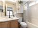 Cozy bathroom features a tub-shower, vanity, and white and wood accents at 10254 Martinsburg Ct, Las Vegas, NV 89183