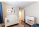 Bright Bedroom with a white crib, animal decor, and a changing table at 10254 Martinsburg Ct, Las Vegas, NV 89183