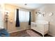 Charming Bedroom featuring hardwood-style floors, a crib with cute decor, and soft lighting for a warm and welcoming space at 10254 Martinsburg Ct, Las Vegas, NV 89183
