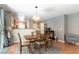 Cozy dining area featuring a wooden table, pendant lighting, and a view into the kitchen at 10254 Martinsburg Ct, Las Vegas, NV 89183