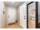 Bright entryway with tile flooring, coat hooks, and a glimpse into the kitchen at 10254 Martinsburg Ct, Las Vegas, NV 89183