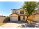 Inviting two-story home with a well-manicured front yard, garage, and desert landscaping at 10254 Martinsburg Ct, Las Vegas, NV 89183