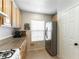 Functional kitchen area showcasing a modern stainless steel refrigerator, sleek white subway tile backsplash, and natural light at 10254 Martinsburg Ct, Las Vegas, NV 89183