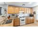 Cozy kitchen featuring wooden cabinets, granite countertops, and modern white appliances for a warm and inviting atmosphere at 10254 Martinsburg Ct, Las Vegas, NV 89183